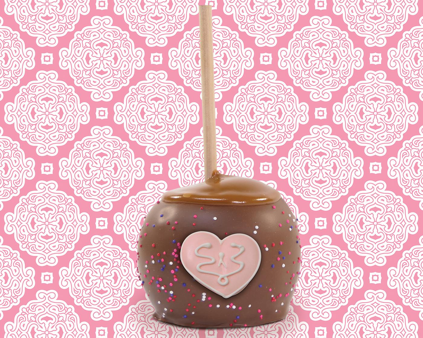 caramel apple dipped in chocolate with sprinkles and valentine decoration