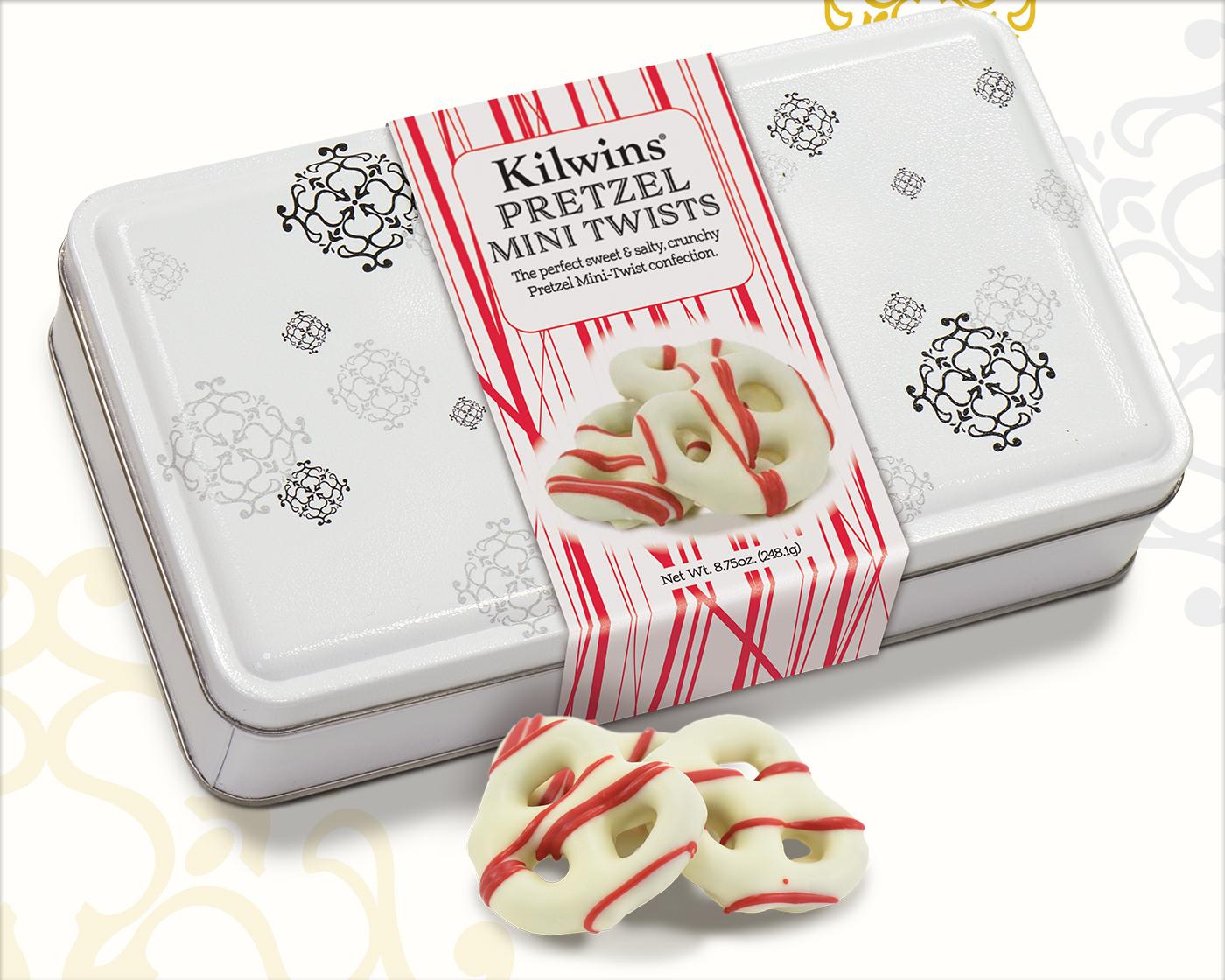 white chocolate covered pretzels striped with red in a Holiday gift tin