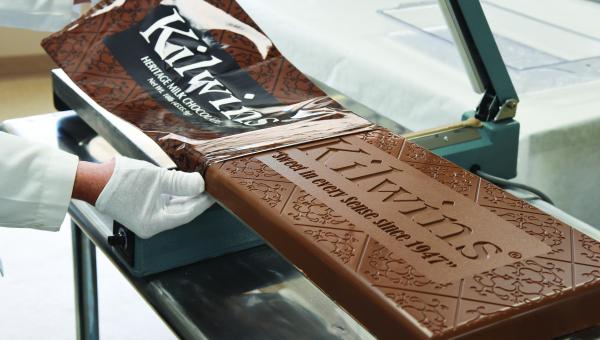 10 Pound Kilwins Heritage Chocolate Bar being placed in a wrapper