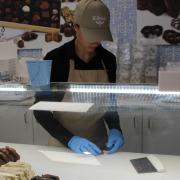 Picture of an employee preparing fudge samples