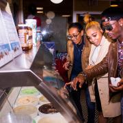 Photo of customers pointing into Ice Cream case