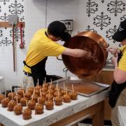 An employee preparing Caramel Apples In Downtown San Antonio 