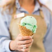 A picture of a woman holding a Kilwins ice cream cone